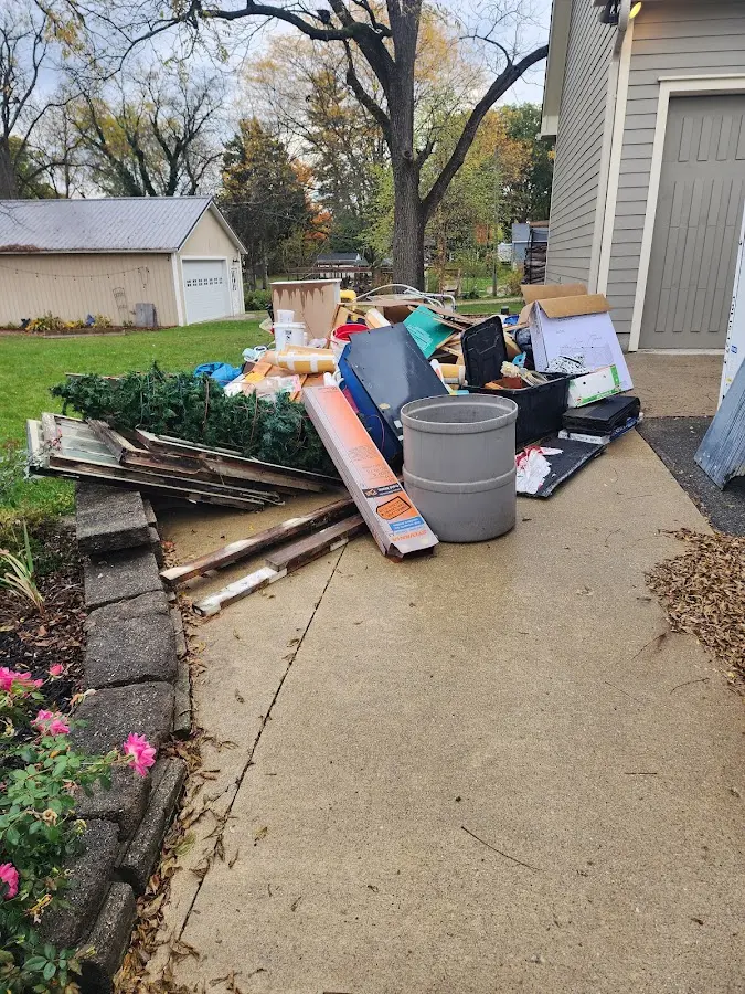 Dumpster being loaded with debris for Roofing Dumpster Rental in Mills River